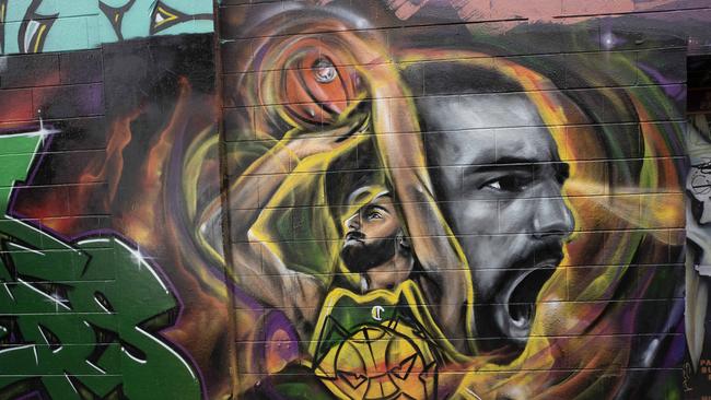 Street artist Rhys Williams and youth worker Joel Imber who have painted a mural of JackJumpers player Jack McVeigh at Bidencopes Lane, Hobart. Picture: Chris Kidd