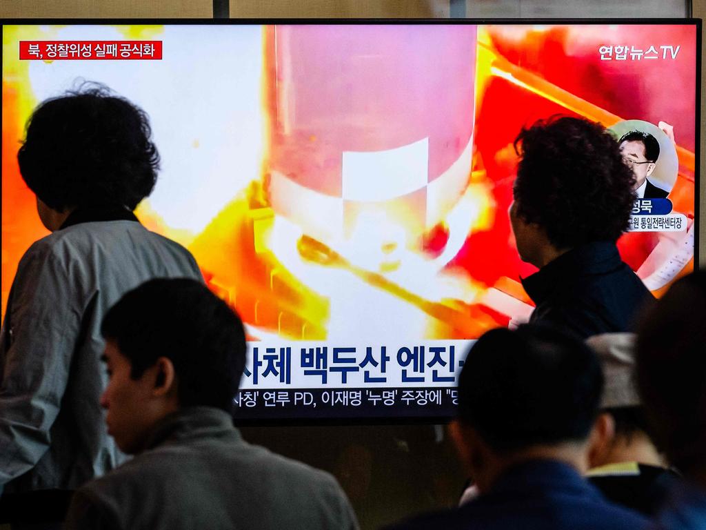 People walk past a television during a news report at a Seoul train station on May 28, after North Korea said late Monday that the rocket carrying its Malligyong-1-1 reconnaissance satellite exploded minutes after launch due to a suspected engine problem. Picture: Anthony Wallace/AFP