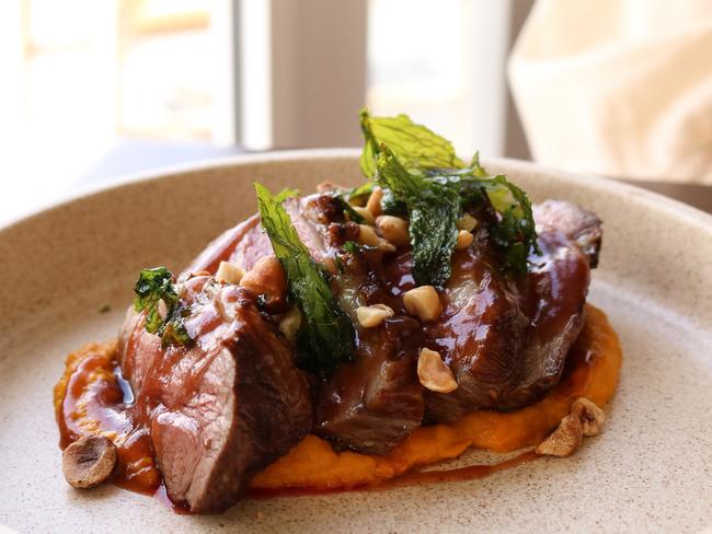 Evenfall’s succulent Tassie lamb rump on a bed of sweet carrot mash sharpened with a smokey pomegranate glaze, crispy mint leaves, and crunchy hazelnuts. Picture: Stephanie Dalton