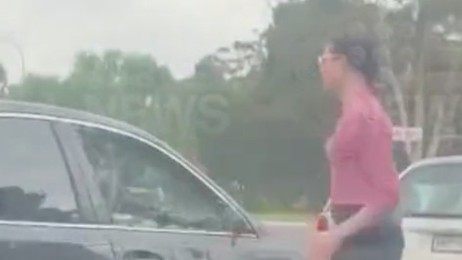 A shocking road rage attack has been captured on camera at Elizabeth, Adelaide, showing a woman kicking a side mirror before using it to smash a driver’s window. Picture: 9News,