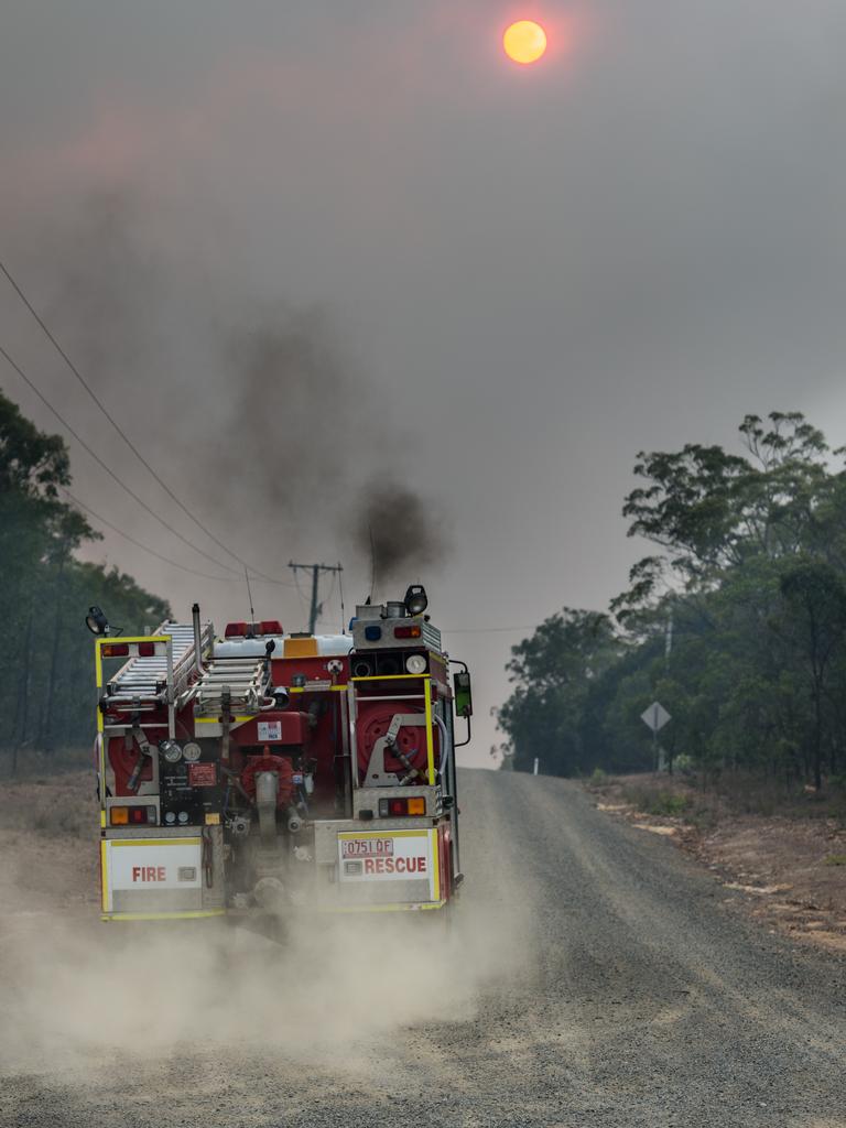 Firefighters head down Pacific Drive in Deepwater. Picture: AAP Image/Paul Beutel