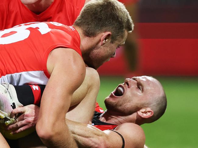 SYDNEY, AUSTRALIA - MARCH 23: Nick Hind of the Bombers is tackled by Braeden Campbell of the Swans during the round two AFL match between Sydney Swans and Essendon Bombers at SCG, on March 23, 2024, in Sydney, Australia. (Photo by Mark Metcalfe/AFL Photos/via Getty Images )