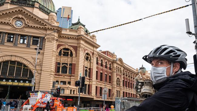 A cyclist rides past Flinders Street station yesterday. Picture: Asanka Ratnayake/Getty Images