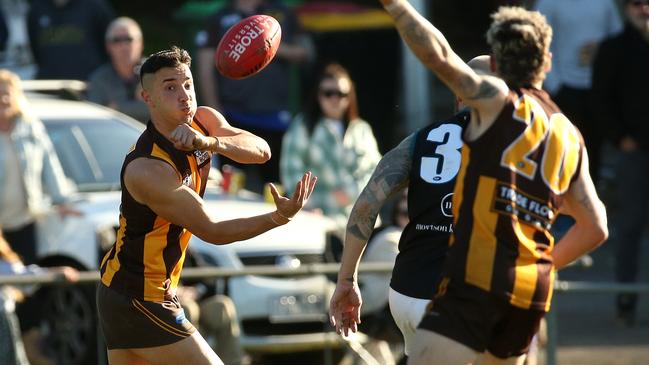 NFL: Jordan Vellios fires off a handball for Heidelberg West. Picture: Hamish Blair