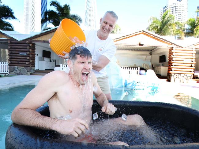 Gold Coast Suns player Zac Smith stripped down to his budgie smugglers to take on the ALS Ice Bucket Challenge, to mark the 10-year anniversary of the viral trend that aims to raise funds and awareness for motor neurone disease. P3 Recovery CEO Paul Goldfinch made sure Zac cooled down at Cali Beach Club in Surfers Paradise.. Picture Glenn Hampson