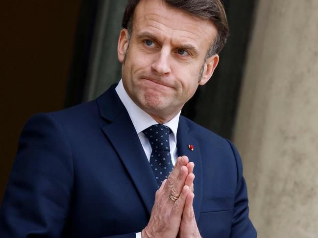 France's President Emmanuel Macron gestures as he waits for Romania's interim President for talks at the Elysee presidential Palace in Paris on February 19, 2025, one day after a meeting with seven European countries, focused on Ukraine, in the belief that âRussia is an existential threatâ to the continent. After bringing together the heavyweights of the European Union, Emmanuel Macron will have spoken to the 27 Member States by the end of the week. (Photo by Ludovic MARIN / AFP)