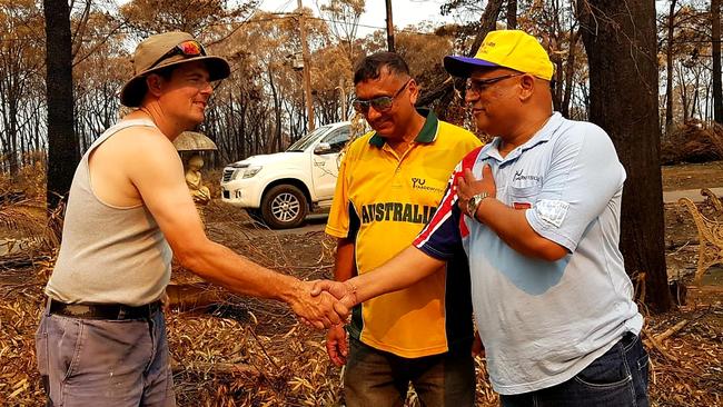 One of the residents in Balmoral greets Fijian Indian community leaders Navnit Anand and Bobby Mishra.