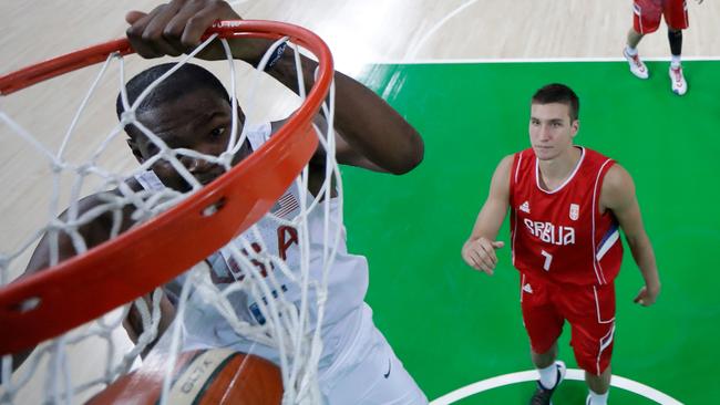 Kevin Durant #5 of United States dunks as Bogdan Bogdanovic #7 of Serbia looks on.