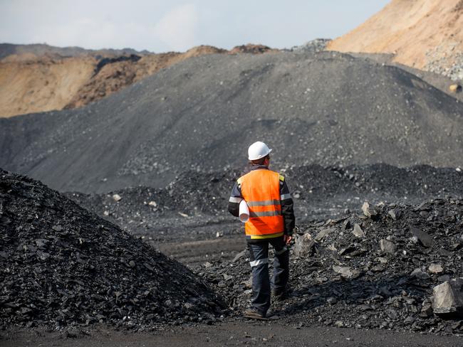 Coal mining in an open pit - Worker is looking on the huge open pit