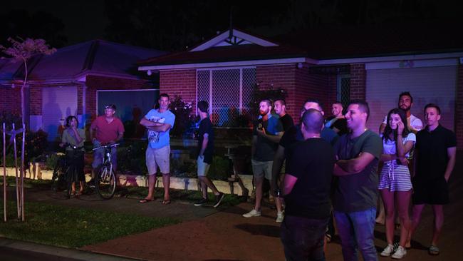 Concerned locals watching flames close to their homes in Corryton Court, Wattle Grove. Picture: AAP