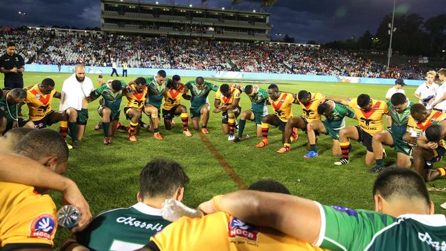 Players say a prayer after the Pacific Test match between the Cook Islands and the Papua New Guinea Kumuls.