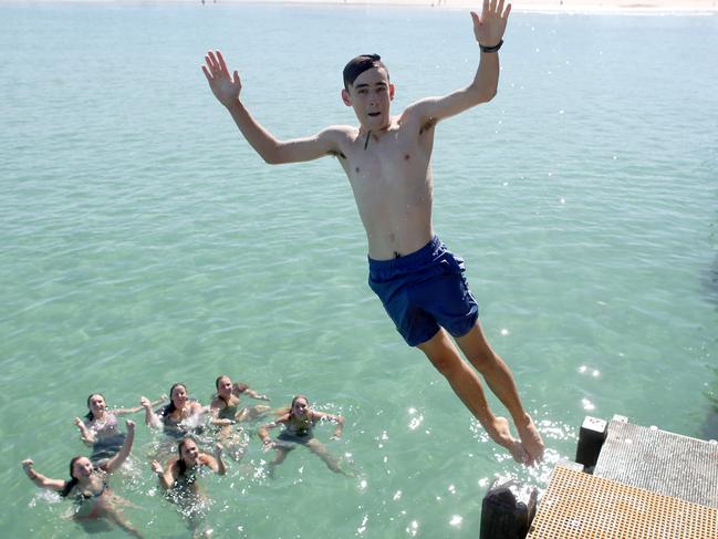 ADELAIDE, AUSTRALIA - NewsWire Photos  Feburary 8, 2023 : Elijah, 17 jumps from the jetty with friends at Henley Beach enjoying the warm weather. Picture: NCA NewsWire / Kelly Barnes