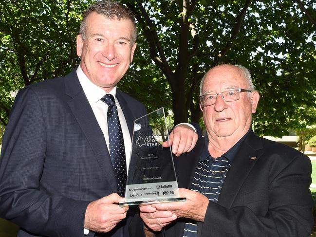 Moonee Valley local sport star winner Ron Stobaus (R) wins national award for efforts in sporting. Pictured with Steve Quartermain presenting his award in Melbourne, Friday, December 15, 2017. (AAP Image/Mal Fairclough) NO ARCHIVING, EDITORIAL USE ONLY