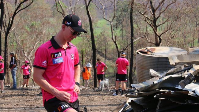 Sydney Sixers player Jordan Silk takes a moment to reflect on the tragic situation at fire ravaged Nymboida during a team visit ahead of their BBL09 fixture with Adelaide Strikers at C.ex Coffs International Stadium.