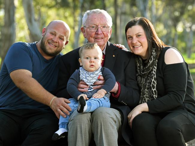 Childhood cancer specialist Dr Michael Rice, 82, pictured at Hazelwood Park with ex-patient Carmine and his wife Nadia and 9-month-old baby. Picture: Tom Huntley