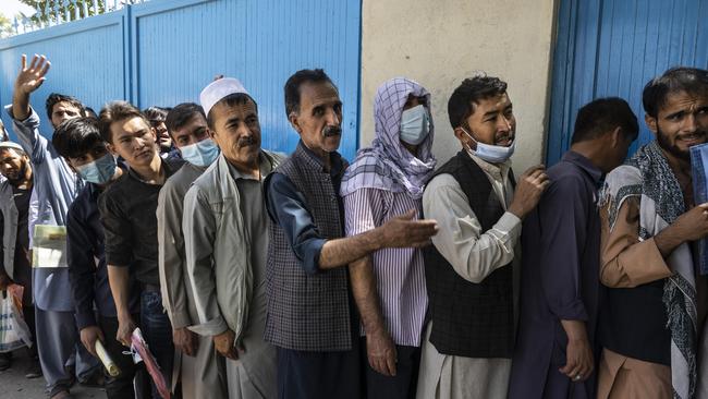 Afghans wait in long lines for hours at the passport office as many are desperate to have their travel documents ready to go in Kabul, Afghanistan. Picture: Getty