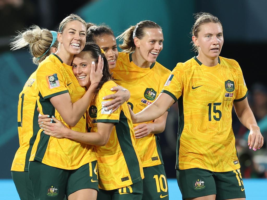 Hugs for a hero: Alanna Kennedy embraces goalscorer Hayley Raso as Australia celebrates beating Denmark to progress to the Quarter Finals. Picture: Matt King/Getty Images