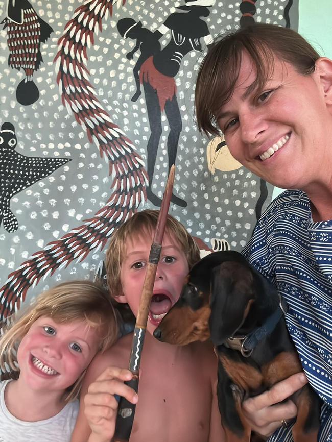 Holly, Hunter and mum Jil Wilson with Mac the mini-dachshund are trying to stay positive as they face a massive recovery effort of their home and businesses after being devastated by the Gulf flooding which swept through Tirranna near Burketown. Picture: Supplied.