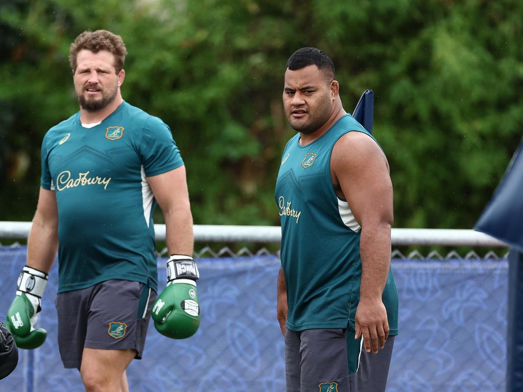 Prop Taniela Tupou (right) watches the Wallabies train. Picture: Chris Hyde/Getty Images