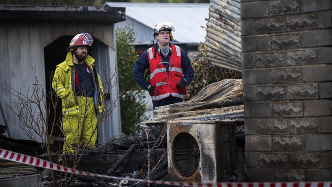 Police and fire investigators at the scene of a house fire at Fourfoot Rd, Geeveston. Picture Chris Kidd