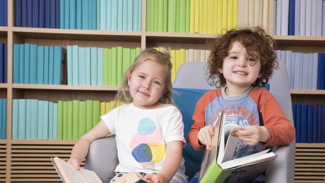 Piper Grundy-Roache age 4, and Ezra Bor enjoying their books at the rainbow all of the Green Square library. (AAP - Flavio Brancaleone)