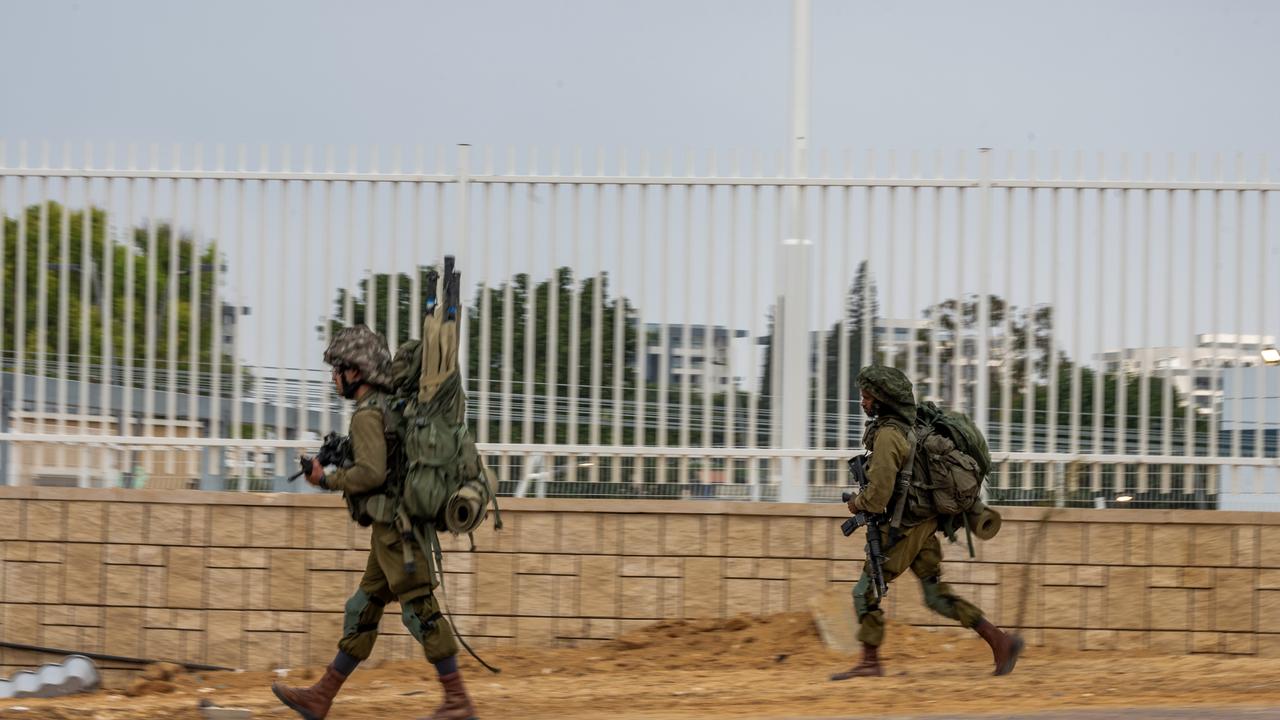 Israel Defense Forces soldiers move through the area in Sderot, Israel.