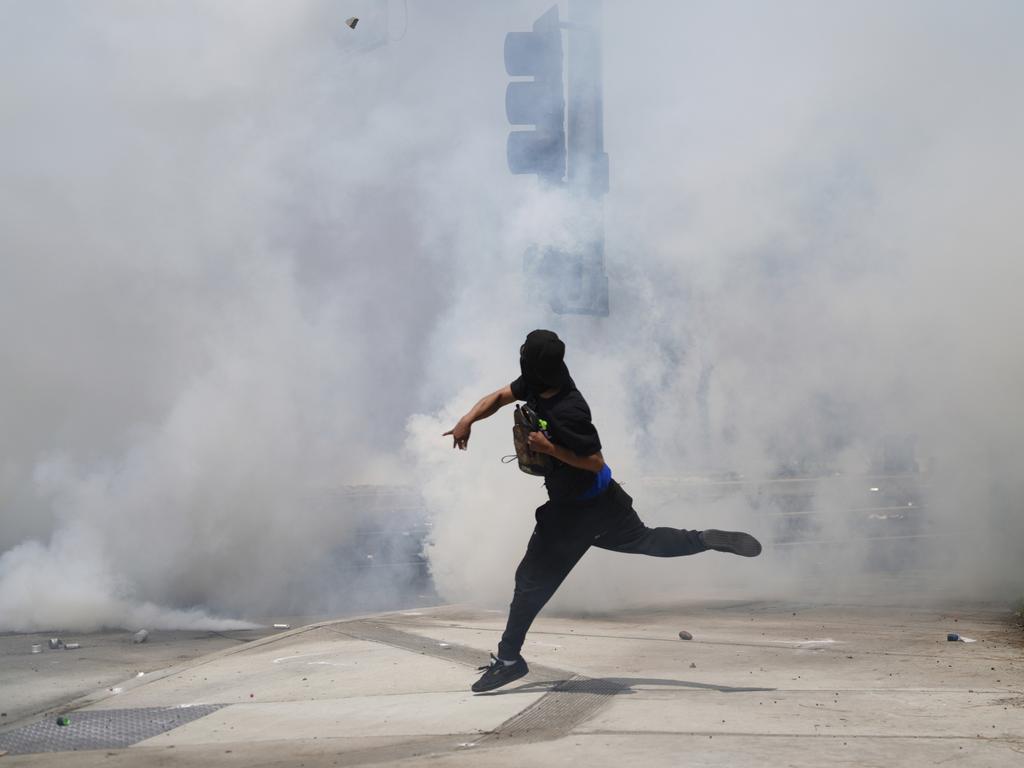 A protester throws a rock during riots in Los Angeles. Picture: AP