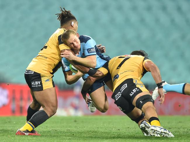 Western Force pair Feleti Kaitu'u (left) and Tevin Ferris (right) tackle Waratahs player Joey Walton. Picture: PETER PARKS/AFP