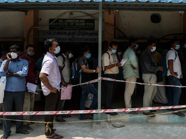 People queue outside a government dispensary to buy Remdesivir, an antiviral drug used to treat COVID-19 coronavirus symptoms, in Chennai on April 27, 2021. Picture: Arun SANKAR / AFP