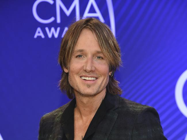 Singer/songwriter Keith Urban poses in the press room with the entertainer of the year award at the 52nd annual CMA Awards at Bridgestone Arena on Wednesday, Nov. 14, 2018, in Nashville, Tenn. (Photo by Evan Agostini/Invision/AP)