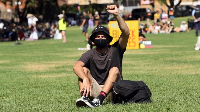 Demonstrators sat distanced on the grass. Picture: Richard Dobson