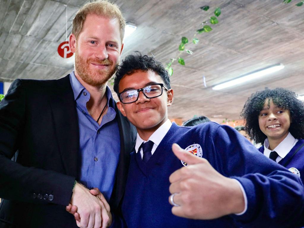 Harry shaking hands with a student of the Popular Cultural School in Bogota. Picture: Andres Castilla/ Colombian Vice-Presidency / AFP