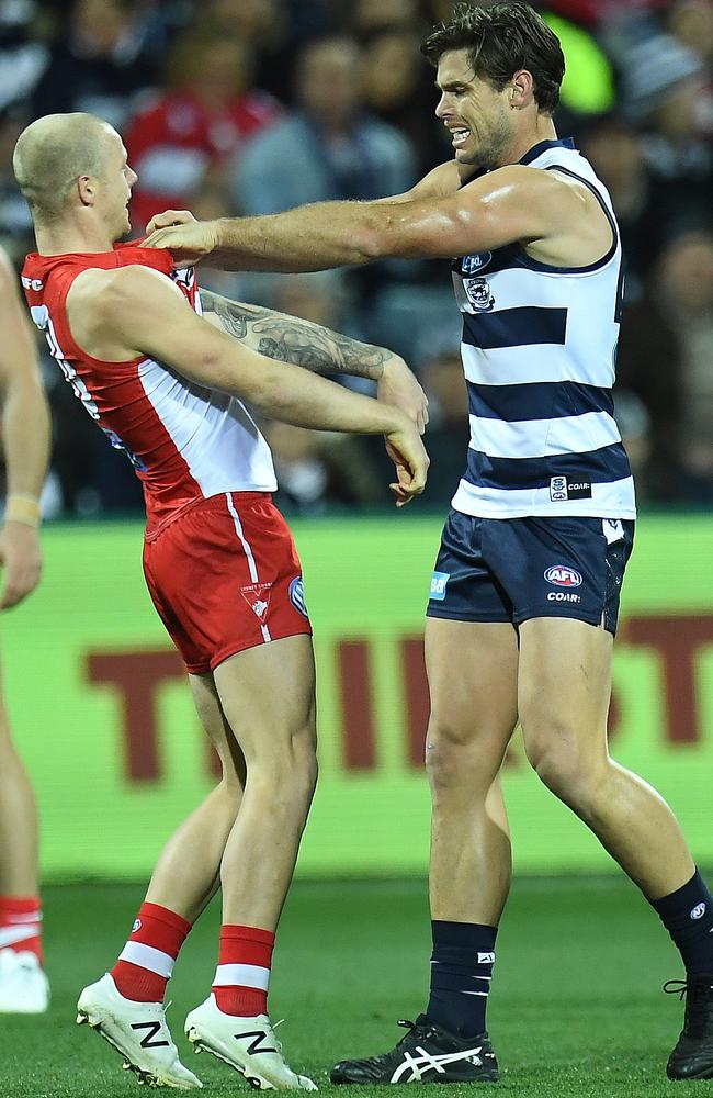 Zak Jones of the Swans and Tom Hawkins the Cats wrestle during Round 20.