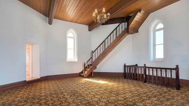 Church-style windows and timber features. But how cool are those carpets?