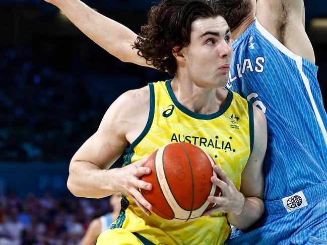 Australia's #03 Josh Giddey drives to the basket past Greece's #16 Kostas Papanikolaou in the men's preliminary round group A basketball match between Australia and Greece during the Paris 2024 Olympic Games at the Pierre-Mauroy stadium in Villeneuve-d'Ascq, northern France, on August 2, 2024. (Photo by Sameer Al-Doumy / AFP)