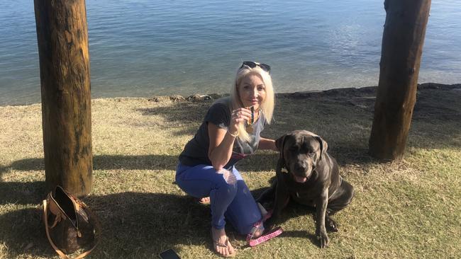 Michelle Chodat, 50, and dog Koda at the spot in Winders Park where she found eight War Medals. Supplied