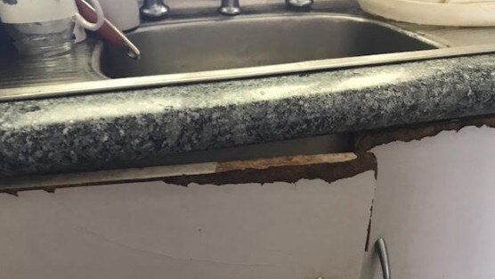 Cupboards a landlord failed to repair under a kitchen sink.