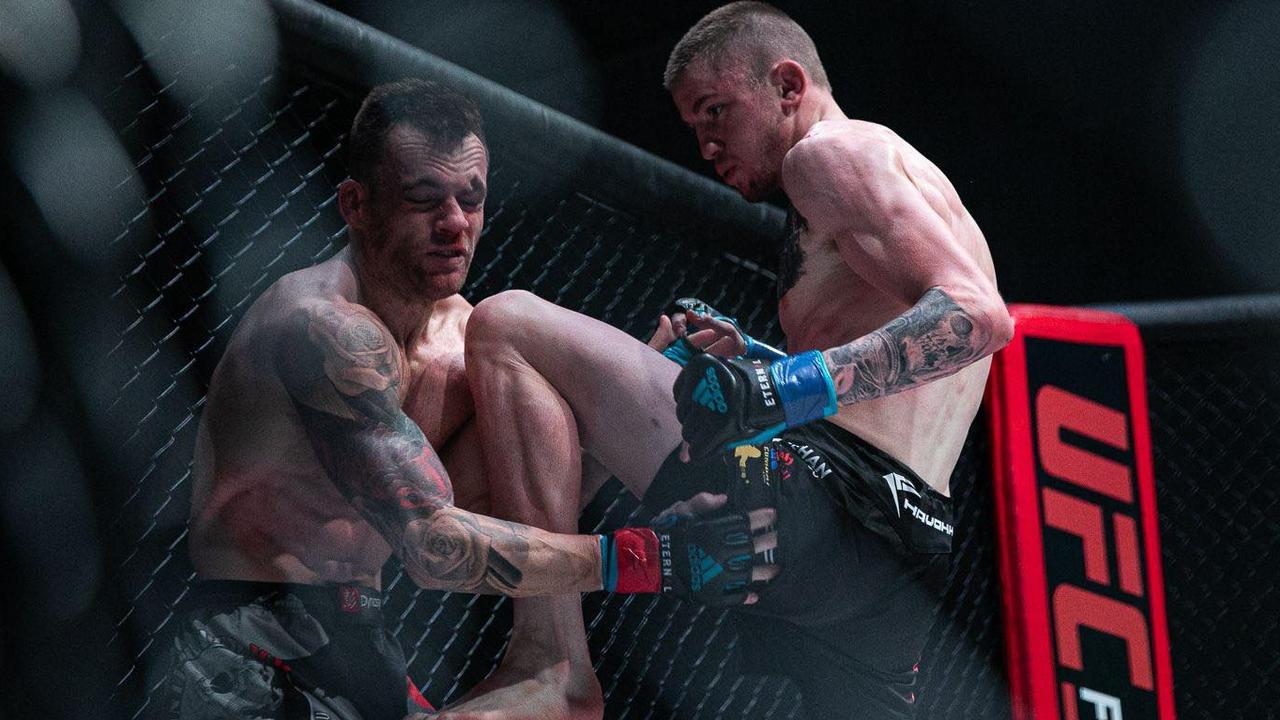 Toowoomba MMA fighter Tom "Big Train" Nolan applies pressure to Trevor Sinclair during their bout at Carrara Stadium on the Gold Coast.