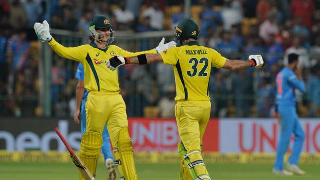 Glenn Maxwell (R) and Peter Handscomb embrace after the victory which reminded Australia they could win again. Picture: AFP