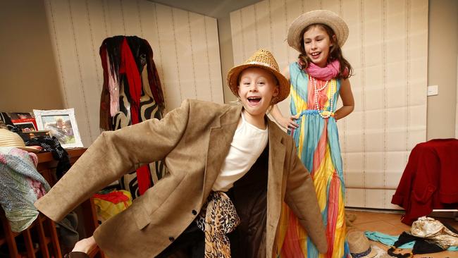 Beating the school holidays blues sisters Jessi 5, and Maddi 8, love playing dress ups at home with their parents clothes. Picture: David Caird