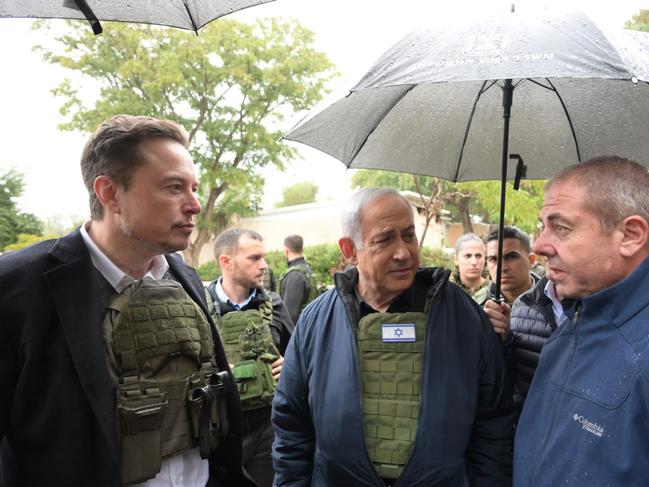 KRAR AZA, ISRAEL - NOVEMBER 27: In this handout image provided by the GPO, Israel's Prime Minister Benjamin Netanyahu (C) takes Elon Musk (L) on a tour of Kibbutz Kfar Aza after the October 7th Massacre took place there, on November 27, 2023 in Kfar Aza, Israel. Billionaire and boss of the social network X, Elon Musk, travelled to Israel during the truce between Israel and Hamas. Musk is due to speak with Israeli President Isaac Herzog about the online fight against anti-Semitism. (Photo by Amos Ben-Gershom (GPO) Handout via Getty Images)