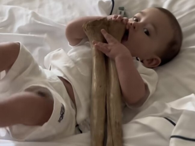 Adrian Portelli has bought - and broken - a T-Rex foot for $130,000. He made the purchase in July 2024. The foot is pictured with his baby son Mercy.Picture: Supplied/Instagram
