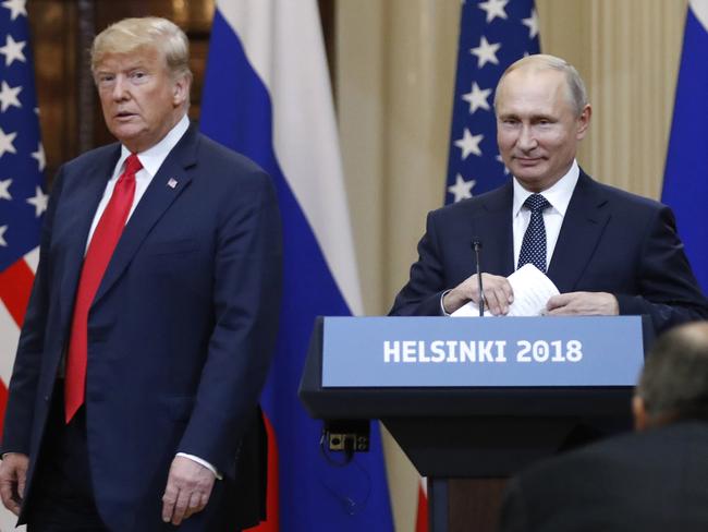 FILE - In this July 16, 2018, file photo, U.S. President Donald Trump, left, and Russian President Vladimir Putin arrive for a press conference after their meeting at the Presidential Palace in Helsinki, Finland. If Donald Trump is serious about his public courtship of Vladimir Putin, he may want to take pointers from one of the Russian leader's longtime suitors: Chinese President Xi Jinping. In this political love triangle, Putin and Xi are tied by strategic need and a rare dose of personal affection, while Trump's effusive display in Helsinki showed him as an earnest admirer of the man leading a country long considered America's adversary. (AP Photo/Alexander Zemlianichenko, File)