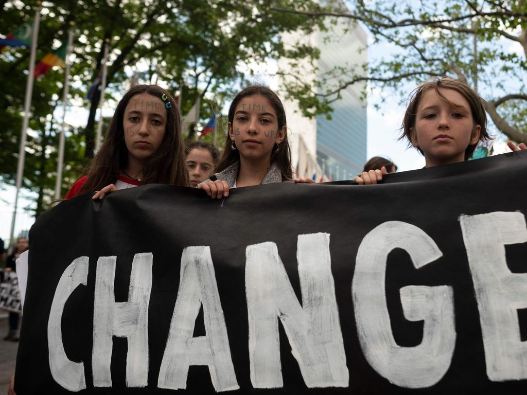 Schoolchildren hold a placard reading ‘CHANGE’ during the Youth Climate Strike on May 24 outside United Nations headquarters in New York City. Picture: Johannes Eisele/AFP