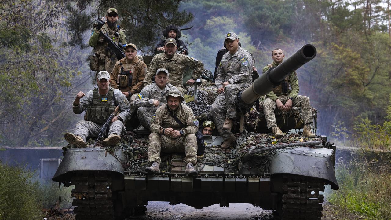 Ukrainian troops ride upon a repaired Russian tank in a wooded area of Kharkiv, Ukraine. Russia’s announcement has raised concerns about a potential broader strike against Europe. Picture: Paula Bronstein