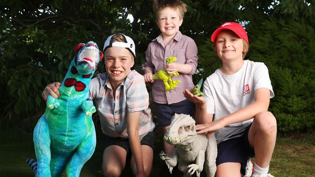 Gus Gray 10, Finn Tremayne 3, Tye Johnson 11 all of Hobart with dinosaurs ahead of the dinosaur show at Wrestpoint in 2021. Picture: NIKKI DAVIS-JONES