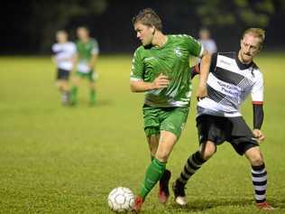 Soccer: Clinton FC's Christopher McDougall and Nerimbera's Michael Cay. Picture: Allan Reinikka ROK160319asoccer5