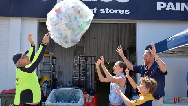 GIVING BACK: Trash walker, Mike Murphy donates another bag of recyclable bottles to Veronica May (12), Zachary May (9) and Kingaroy scout leader Craig Turnley. Picture: Matt Collins