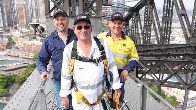 The Daily Telegraph. 30.1.2025 Mirko Cerovac (dad, white overalls) Joe Cerovac (blue shirt), Goran Cerovac (high vis shirt). Mirko has been a painter on The Sydney Harbour Bridge for 32 years and his sons Joe and Goran also work on the bridge.  Picture: Rohan Kelly