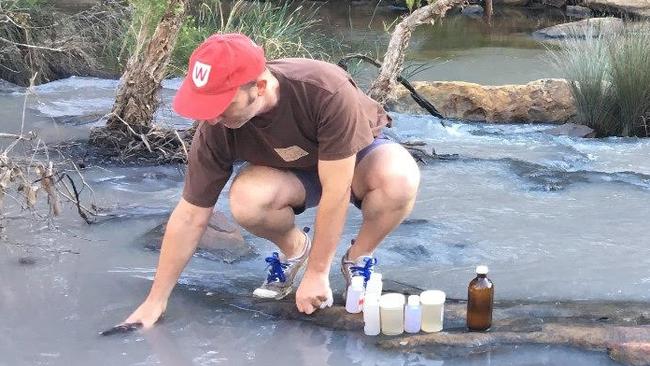 Dr Ian Wright tests water in the river. Picture: Supplied.